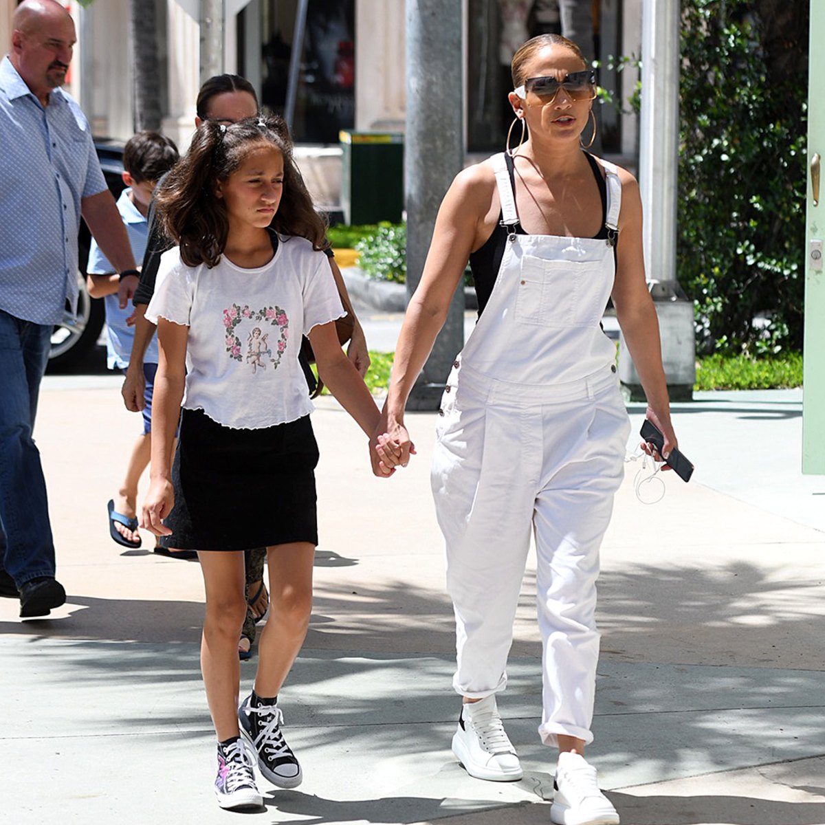 Jennifer Lopez, 49, poses with her mini me daughter Emme, 10, on Christmas