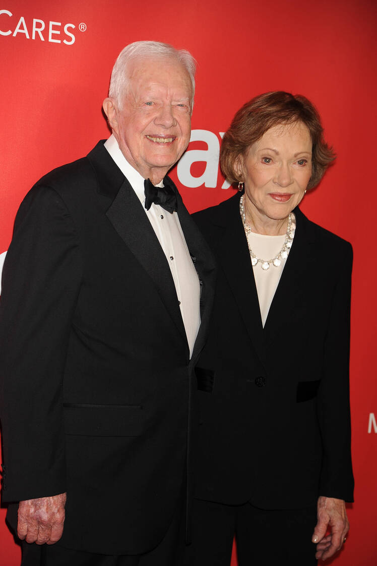 Jimmy Carter smiles next to wife Rosalynn Carter