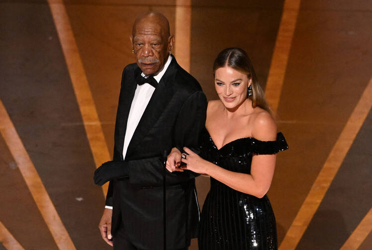 Morgan Freeman wears a glove on his hand at the Oscars