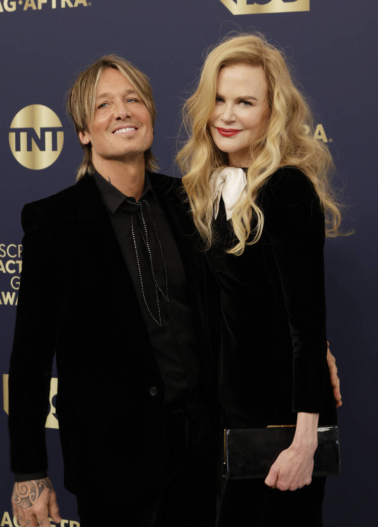Nicole Kidman and Keith Urban pose together while wearing black suits