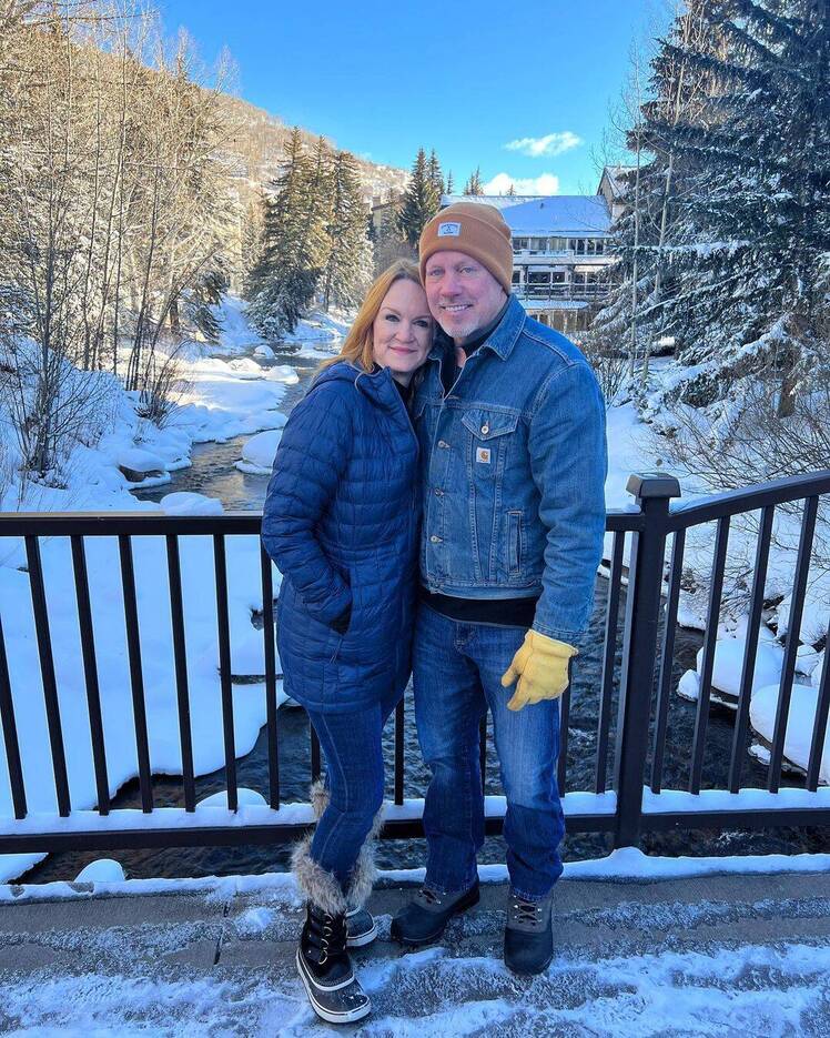 Ree and Ladd Drummond pose in front of snowy backdrop