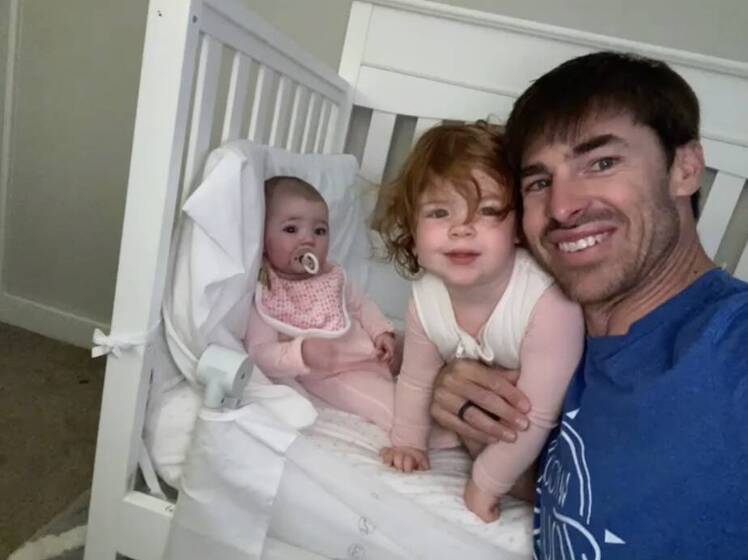 David Ridley poses with his two daughters