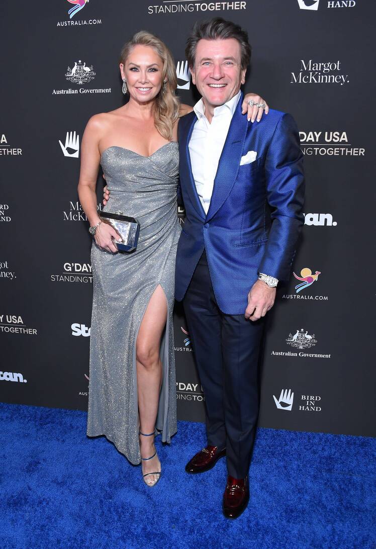 Kym Johnson and Robert Herjavec pose together on red carpet