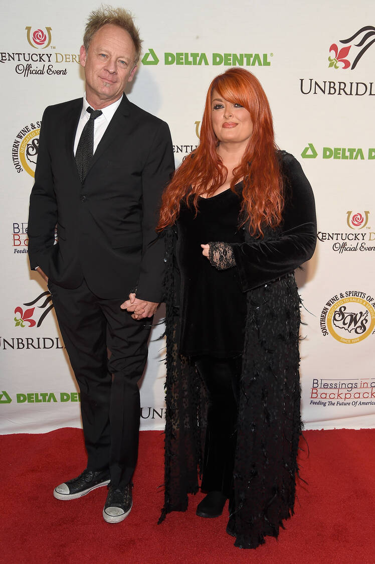 Wynonna Judd holds hands with Cactus Moser