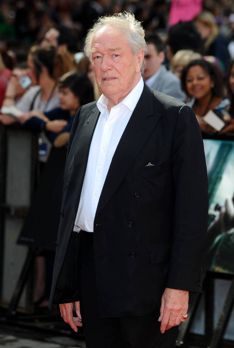 Michael Gambon wears a black suit