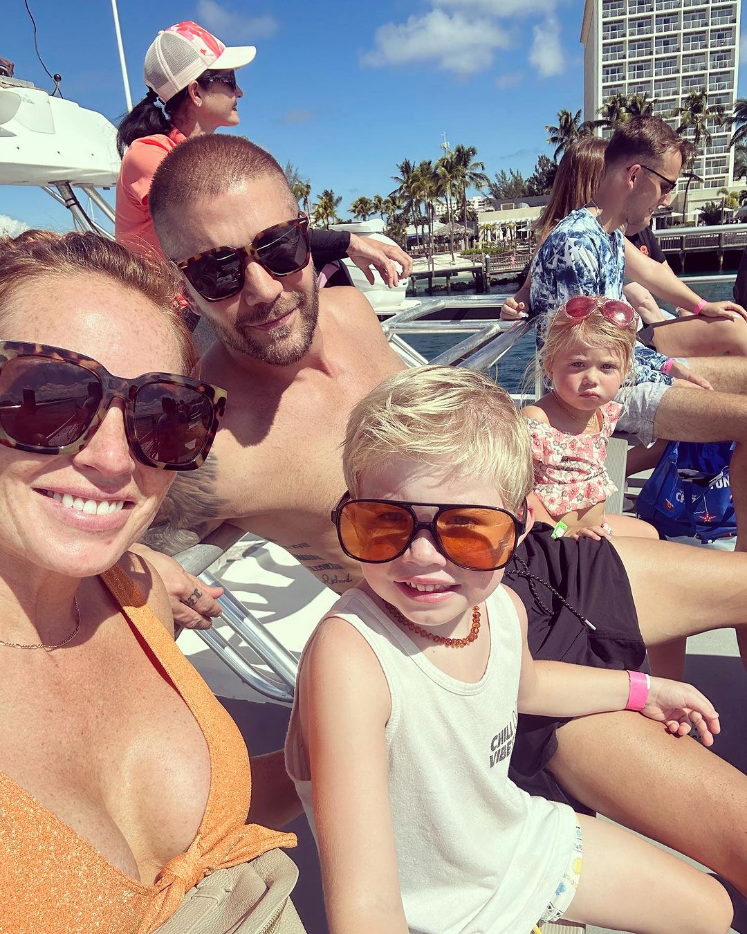 Mina Starsiak Hawk and husband Steve Hawk lounge on beach chairs with kids Jack and Charlotte