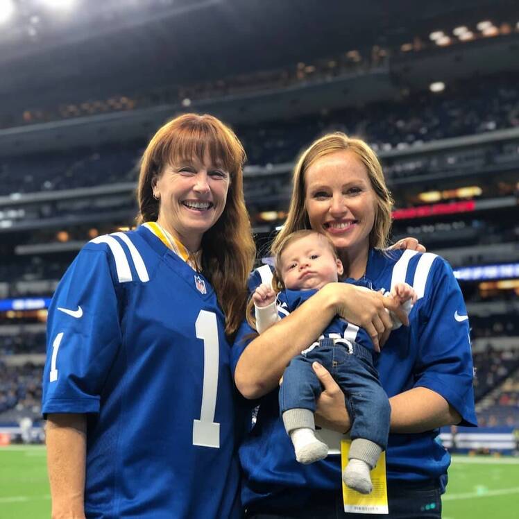 Mina Starsiak Hawk and mom Karen E. Laine wear football jerseys on field