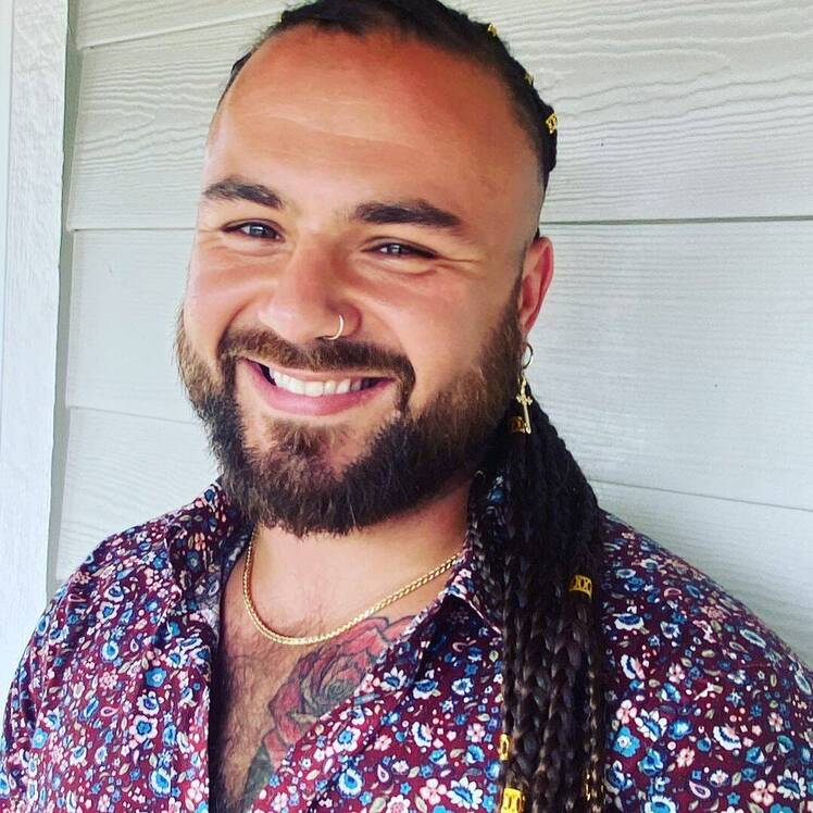 Tad Starsiak smiles at camera wearing floral shirt