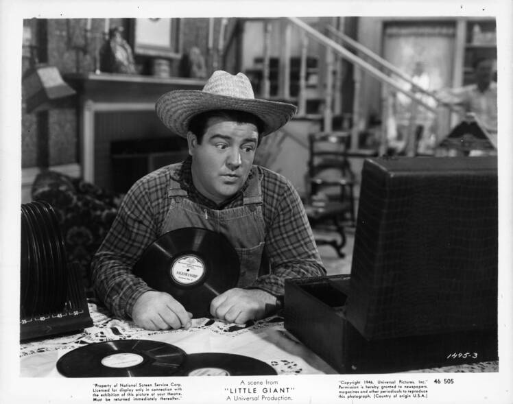 Lou Costello plays records in a scene from the film 'Little Giant'