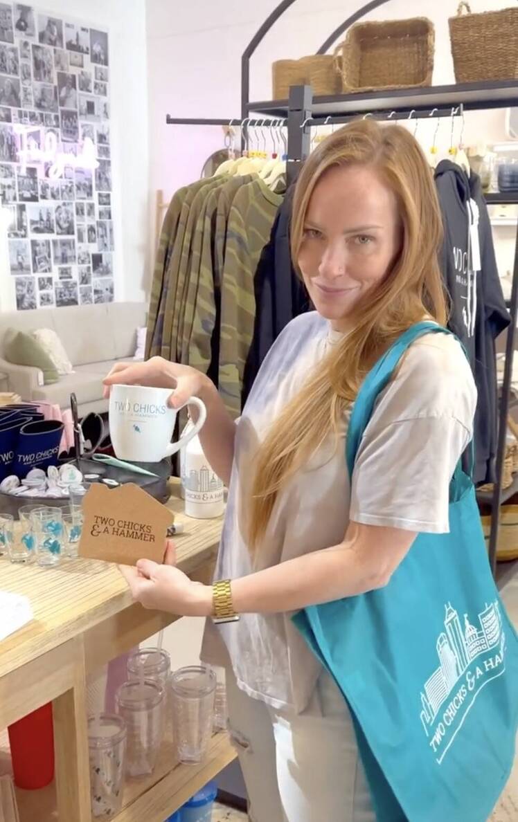 Mina Starsiak Hawk holds tote bag and mug