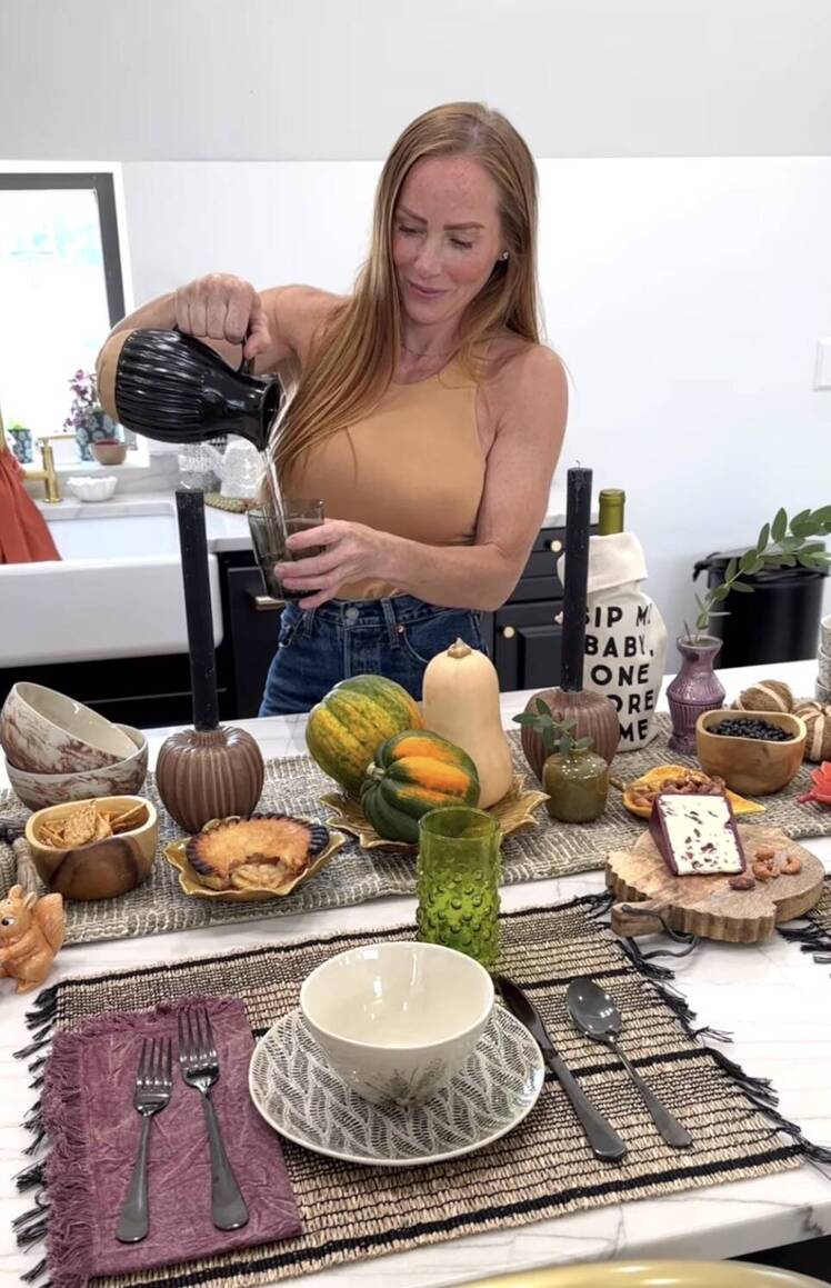 Mina Starsiak Hawk pours a cup of water