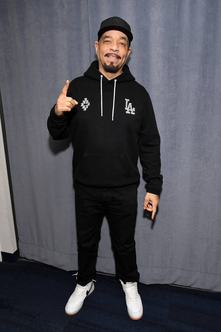 Ice-T wears black hooded sweatshirt and black pants