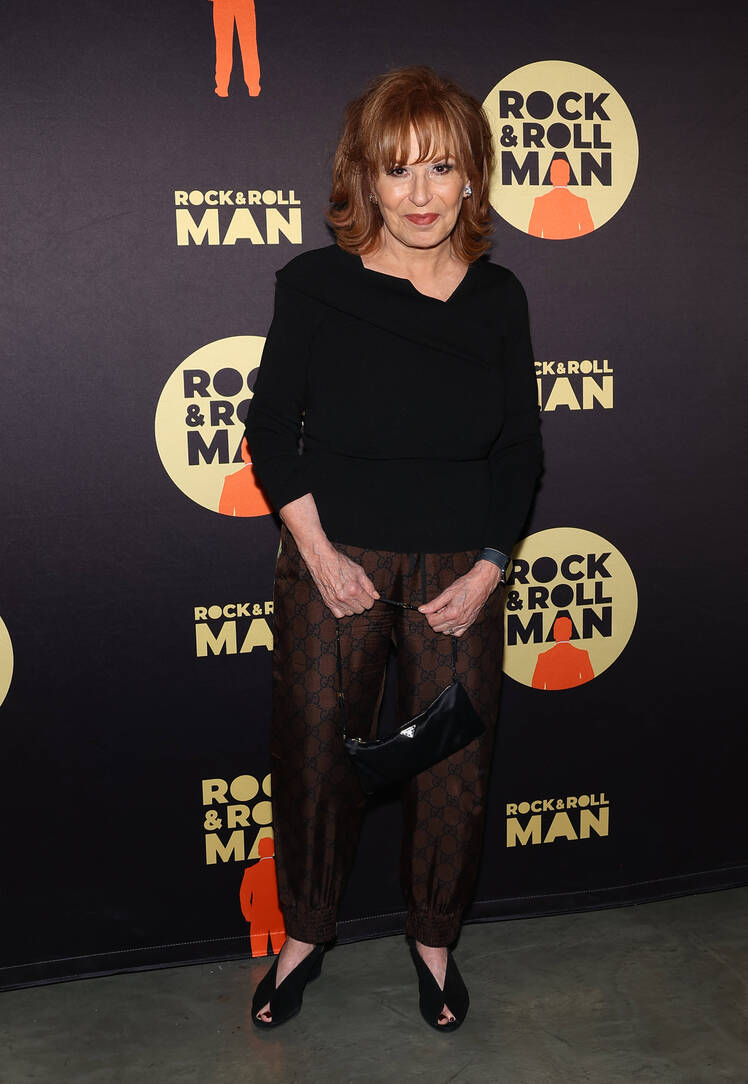 Joy Behar stands with her hands in her pockets