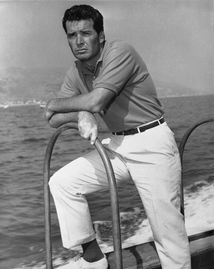 James Garner stands on the deck of a boat