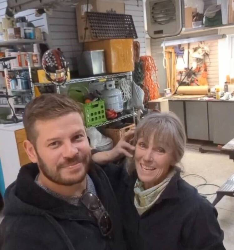 Cory Miller and Karen E. Laine standing in her garage