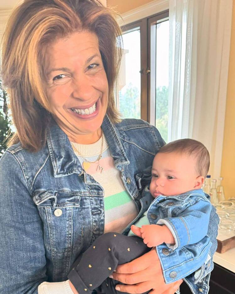 Hoda Kotb holds Al Roker's granddaughter in her arms