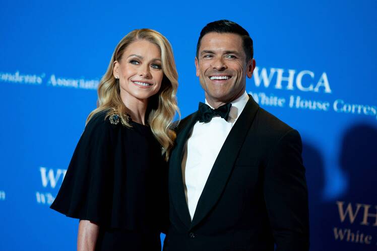 Kelly Ripa smiles in black dress next to husband Mark Consuelos