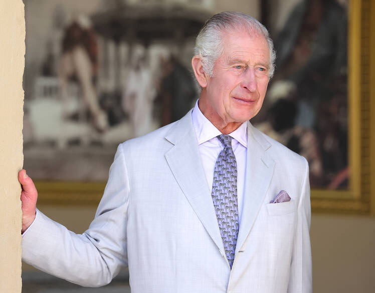King Charles stands in doorway