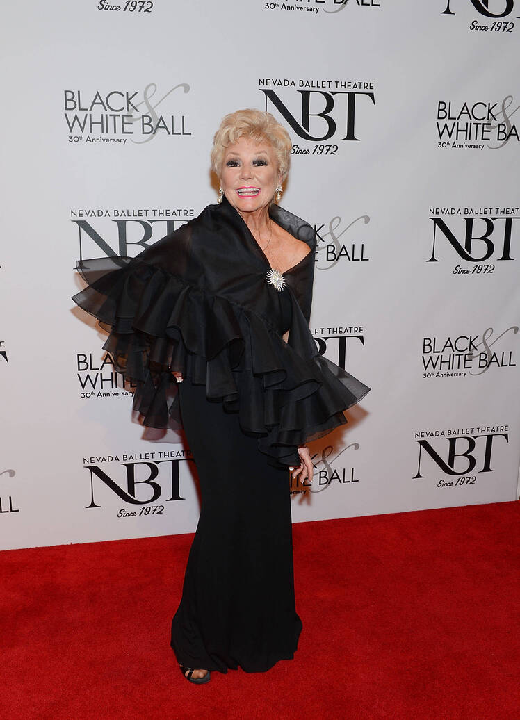 Mitzi Gaynor in a black dress with ruffles