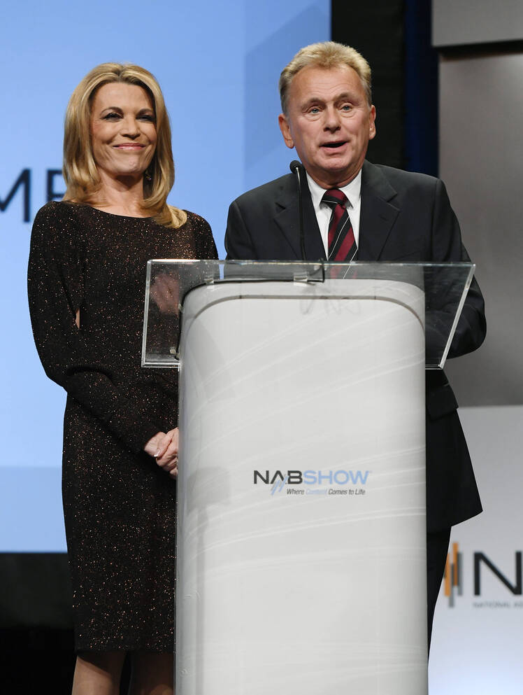 Pat Sajak and Vanna White Stand at Podium