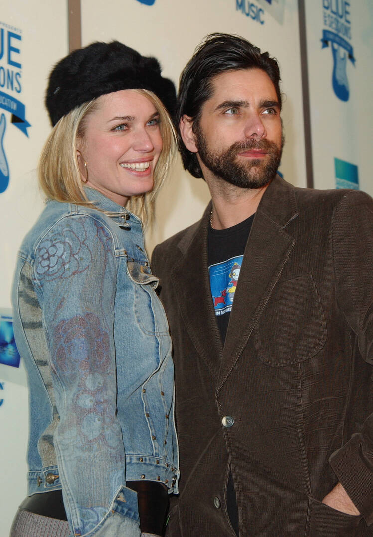 John Stamos hugs Rebecca Romiijn